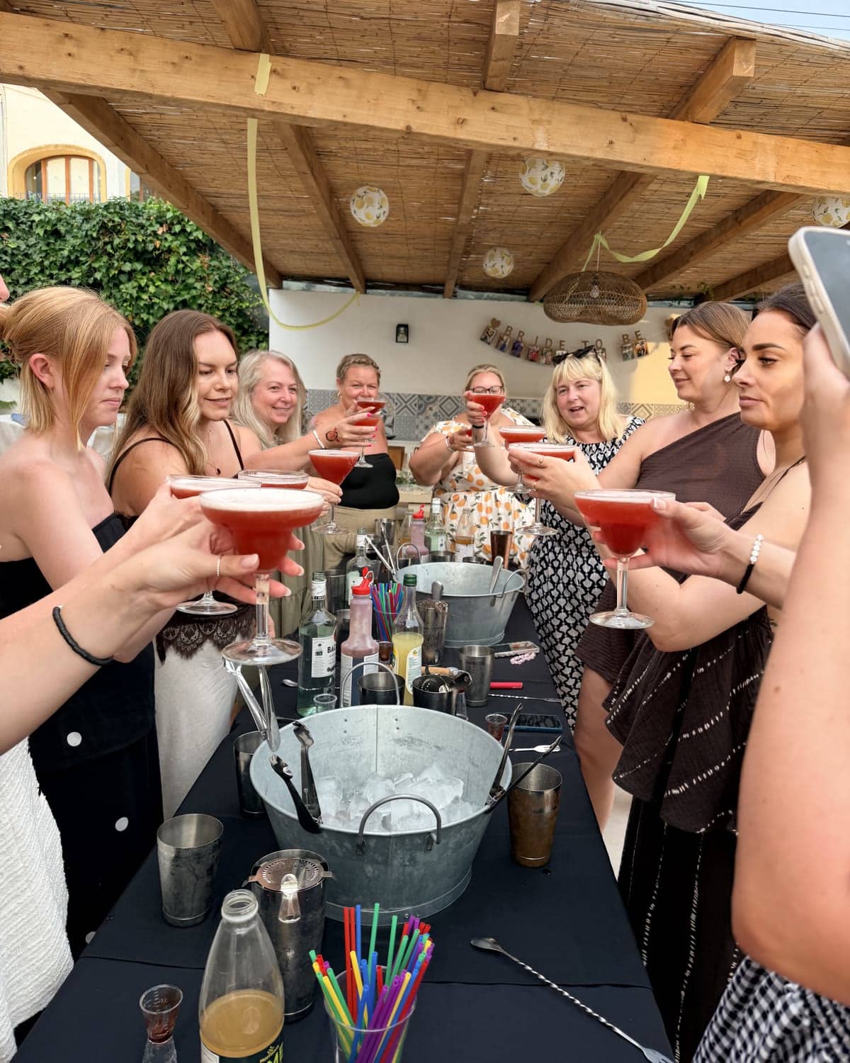 Guests toasting cocktails made in a real villa workshop