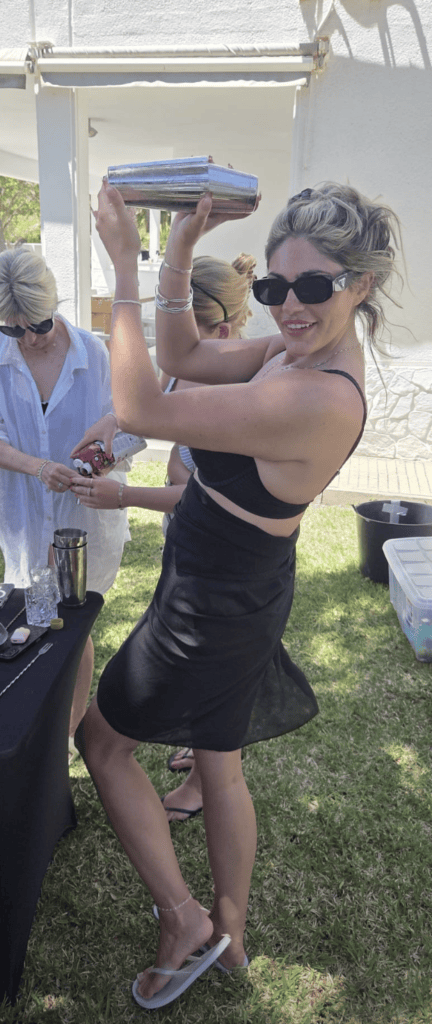 Guest shaking a cocktail during a villa cocktail workshop in Benidorm